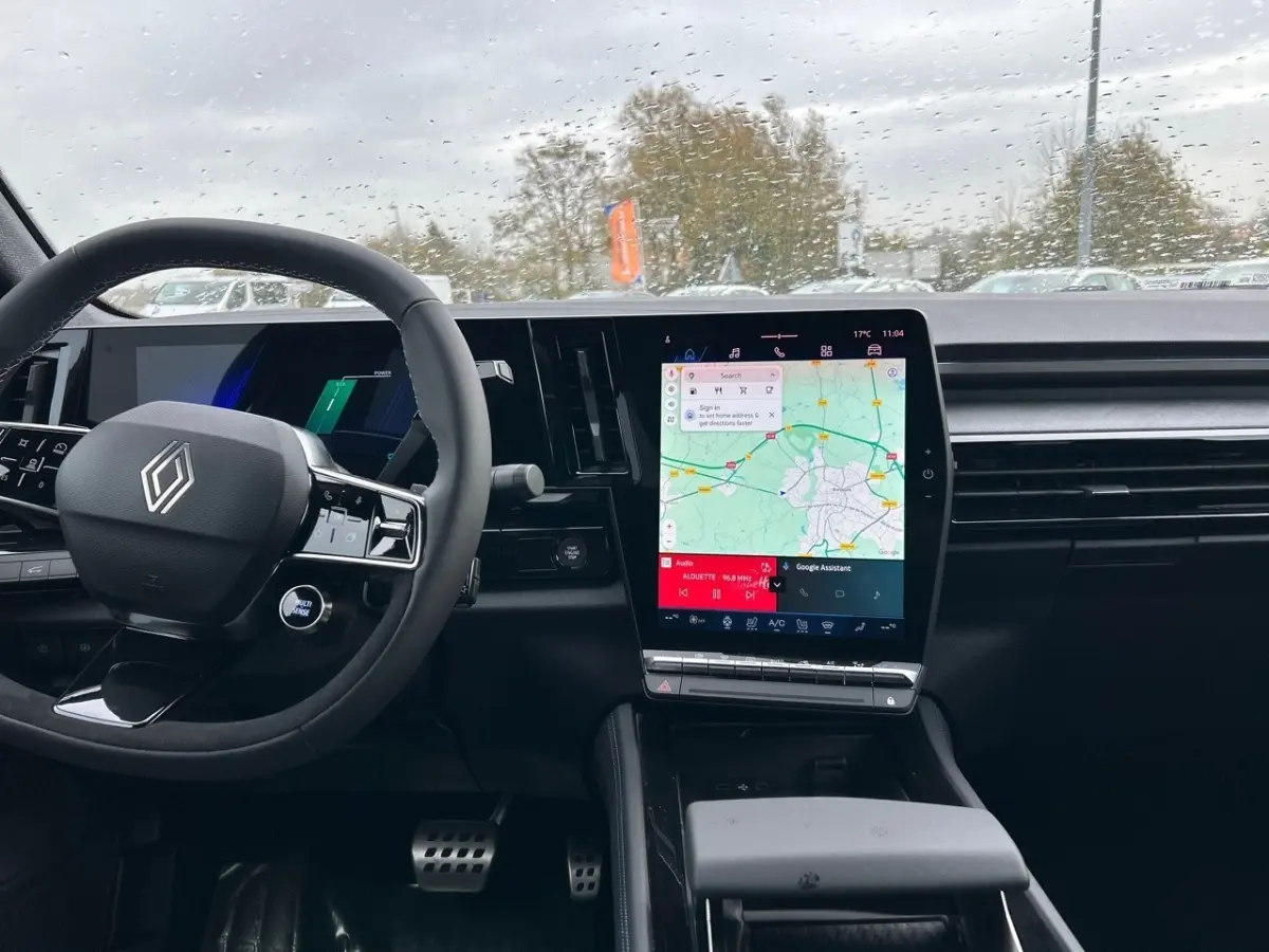 Intérieur noir de la Renault Rafale 2025 esprit Alpine, vue du tableau de bord avec grand écran tactile central affichant une carte.