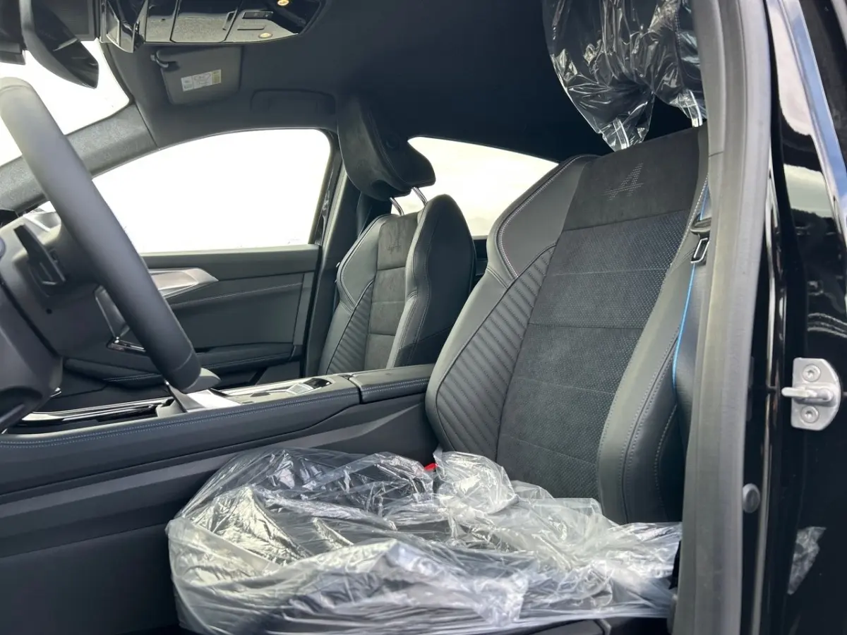 Intérieur côté conducteur de la Renault Rafale noir, sièges sport en alcantara avec logo Alpine brodé.