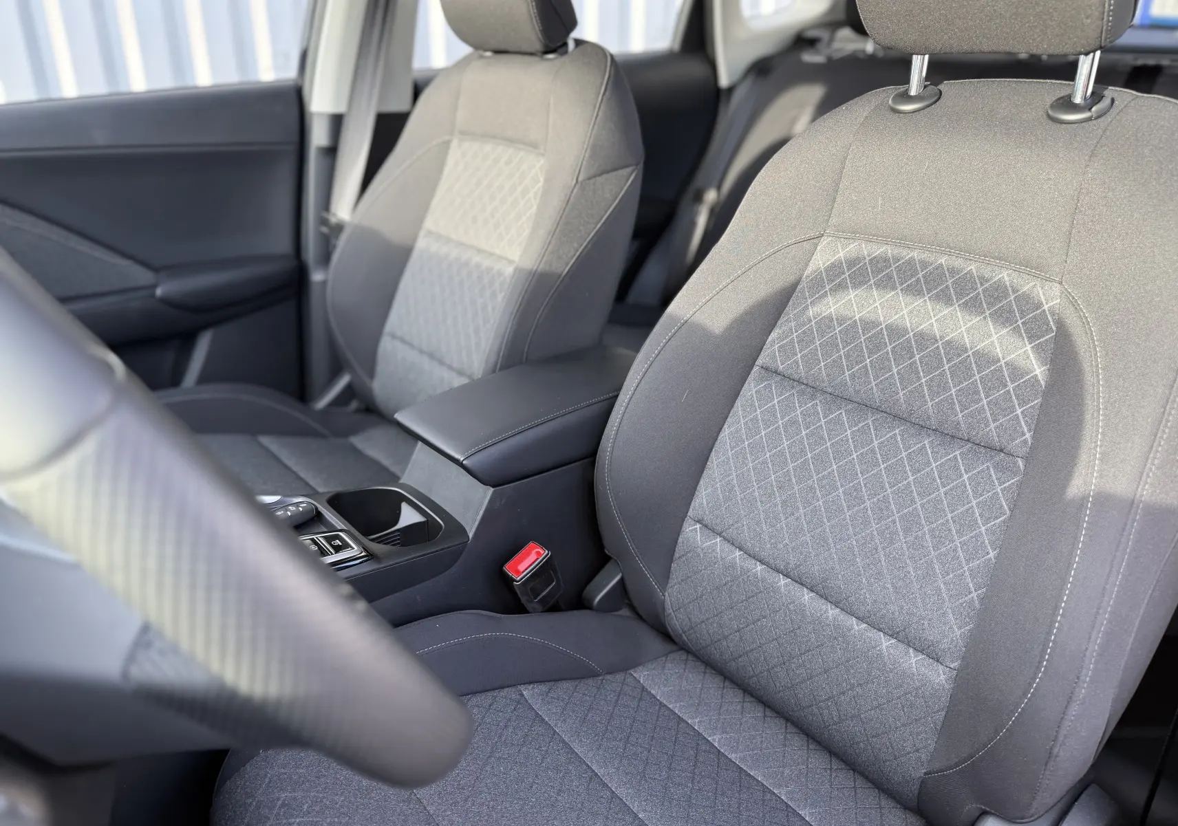 Vue intérieure rapprochée des sièges avant gris à motifs du MG Motor ZS Hybrid 197 Standart 2026 noir.