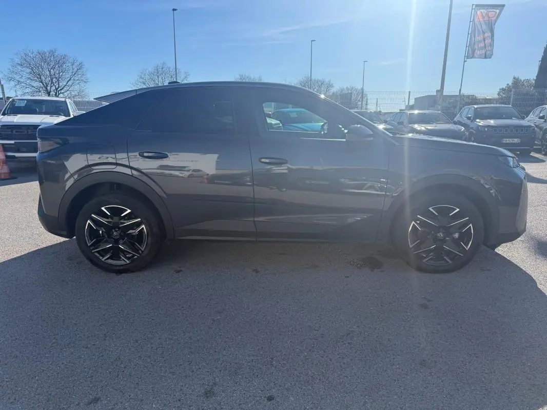 Vue de profil côté gauche d’un Peugeot 3008 Hybrid gris avec jantes alliage 19 pouces, stationné en extérieur.