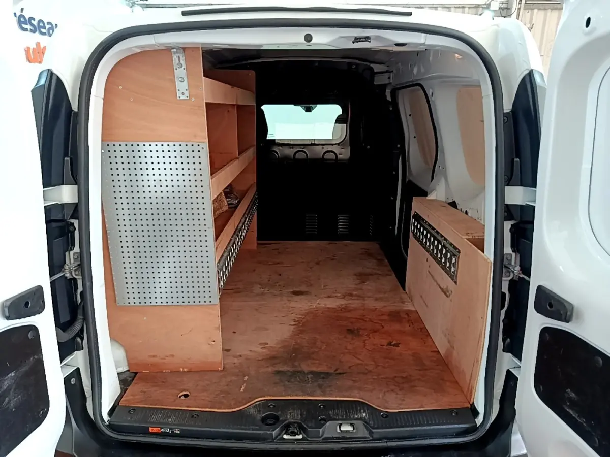 Vue arrière du Renault Express blanc 2021 avec aménagement bois et cloison pleine vitrée dans l’espace de chargement.