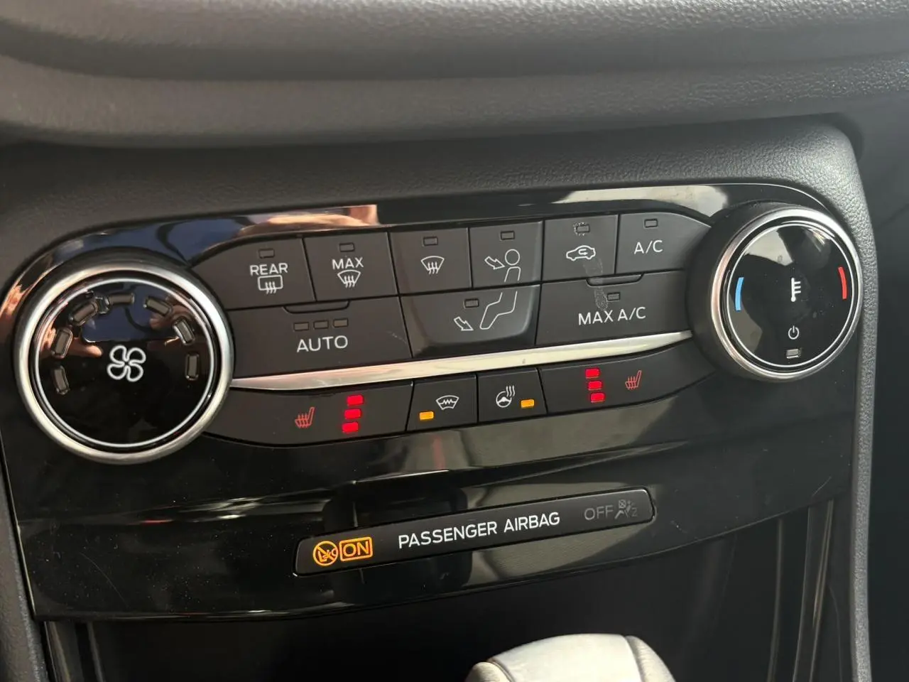 Détail de la console centrale noire du Ford Puma 2023 avec commandes climatisation et sièges chauffants activés.
