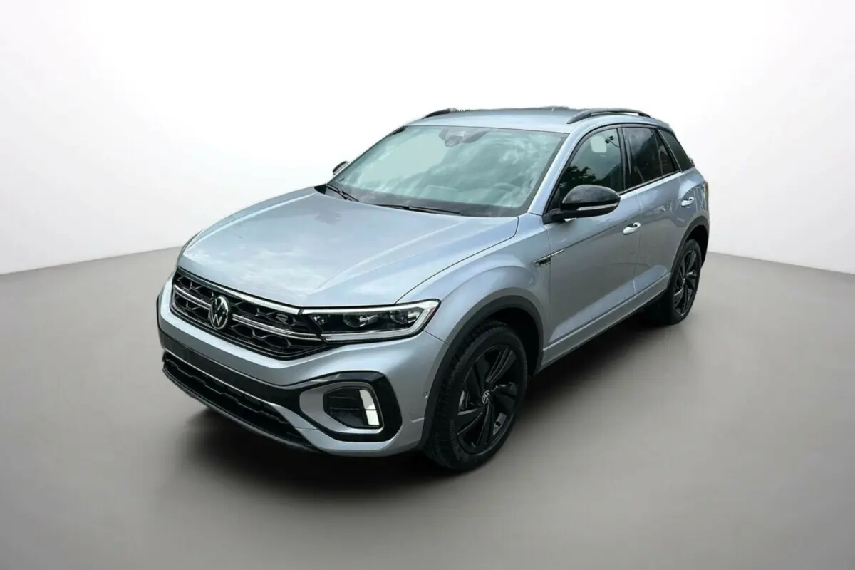 Volkswagen T-Roc TDI 150 R-Line Black gris pyrite en 3/4 avant droit avec jantes noires et barres de toit noires.