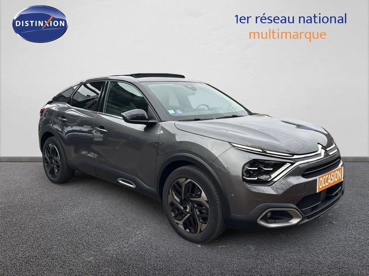 Citroën C4 PureTech 130ch gris avec toit noir, vue 3/4 avant droit mettant en valeur ses phares LED et jantes noires.