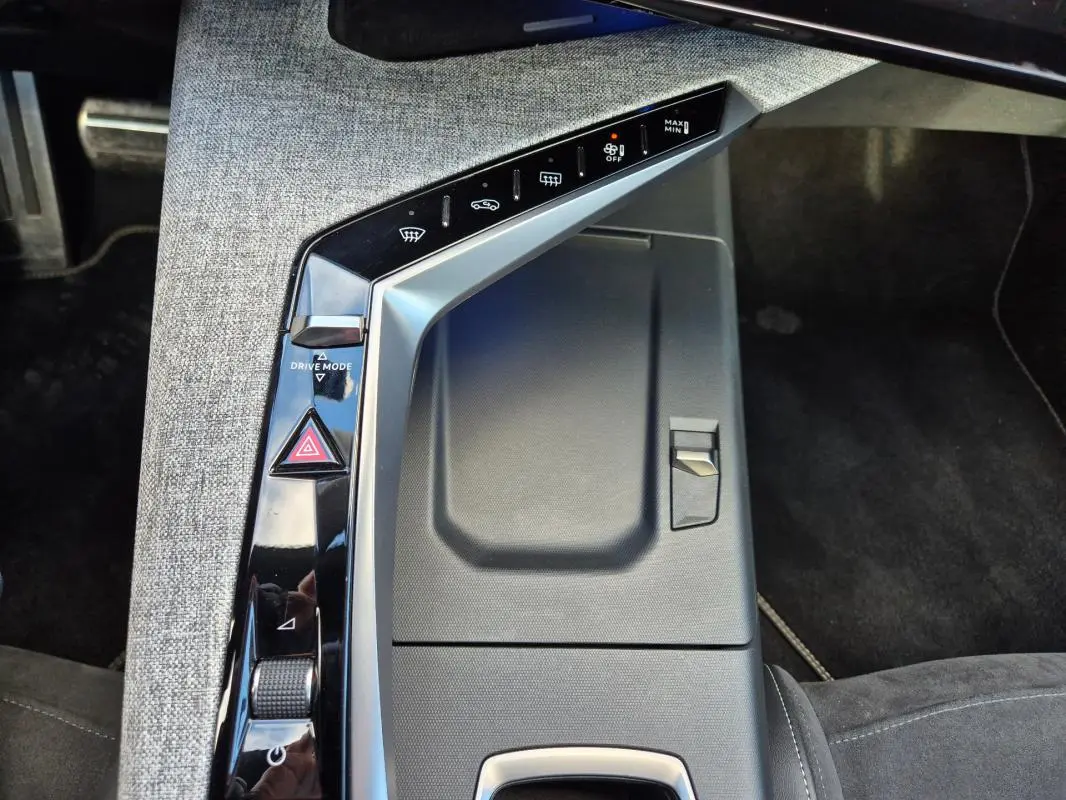 Vue rapprochée de la console centrale grise du Peugeot 3008 Hybrid 136 e-DCS6 GT avec commandes tactiles et bouton Drive Mode.