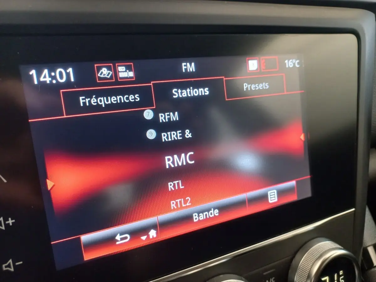 Gros plan sur l'écran tactile multimédia du Renault Kadjar Business gris foncé, affichant les stations radio FM.