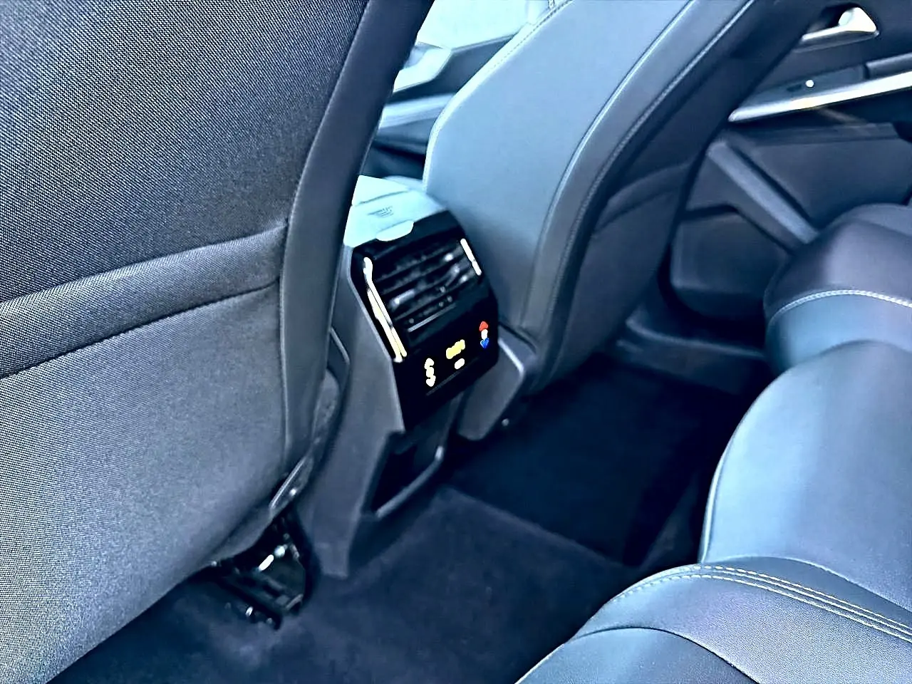 Vue intérieure arrière droite du Peugeot 5008 Hybrid 145 allure e-dcs6 2025, sièges en tissu gris et climatisation tri-zone.
