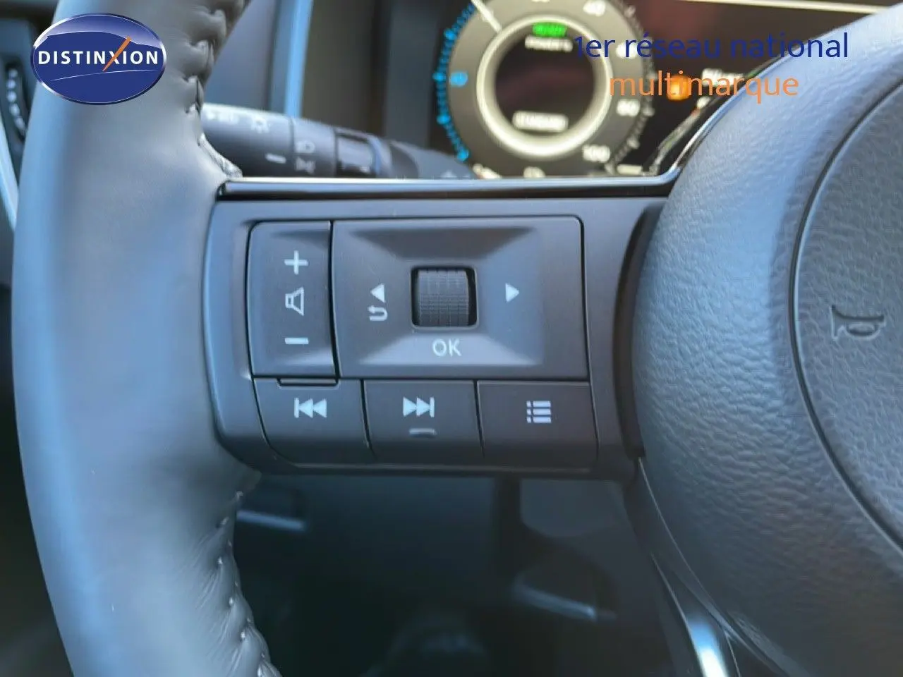 Gros plan sur les commandes multifonctions à gauche du volant cuir du Nissan Qashqai gris argile 2025.