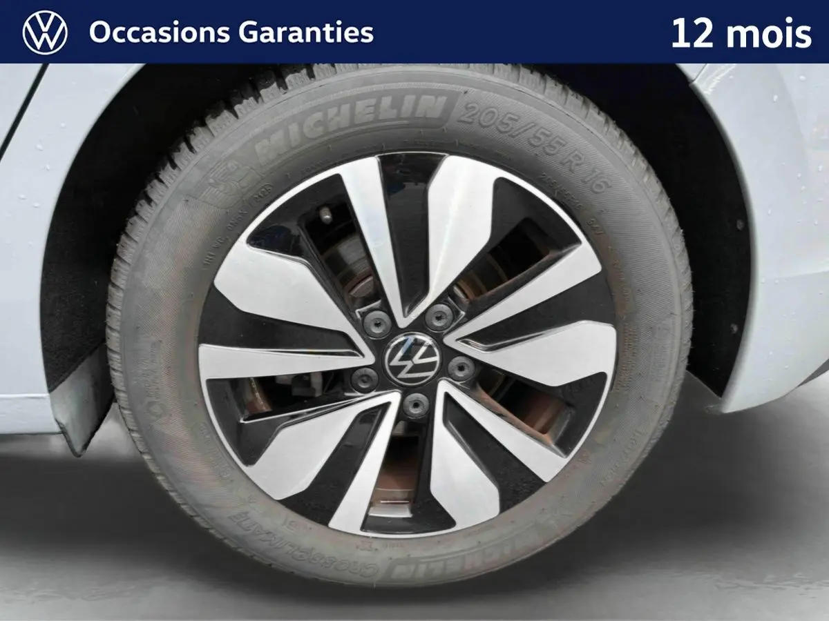 Gros plan sur la jante alliage 16'' Zurich bicolore et pneu Michelin 205/55 R16 d’une Volkswagen Golf grise.