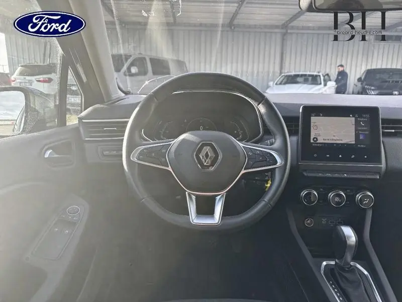 Vue intérieure centrée sur le volant noir de la Renault Clio hybride 2021 avec écran tactile et commandes au volant.