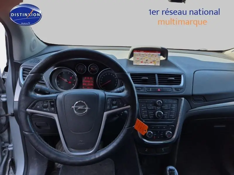 Vue intérieure centrée sur le volant cuir multifonction et le tableau de bord avec écran GPS de l'Opel Mokka gris Astéroïde.