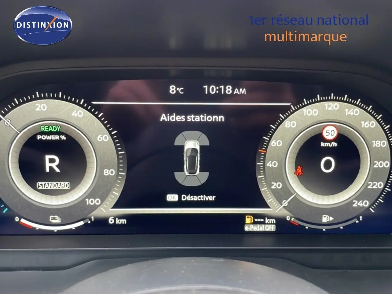 Tableau de bord numérique du Nissan Qashqai noir perle, affichant les aides au stationnement et la vitesse à 0 km/h.