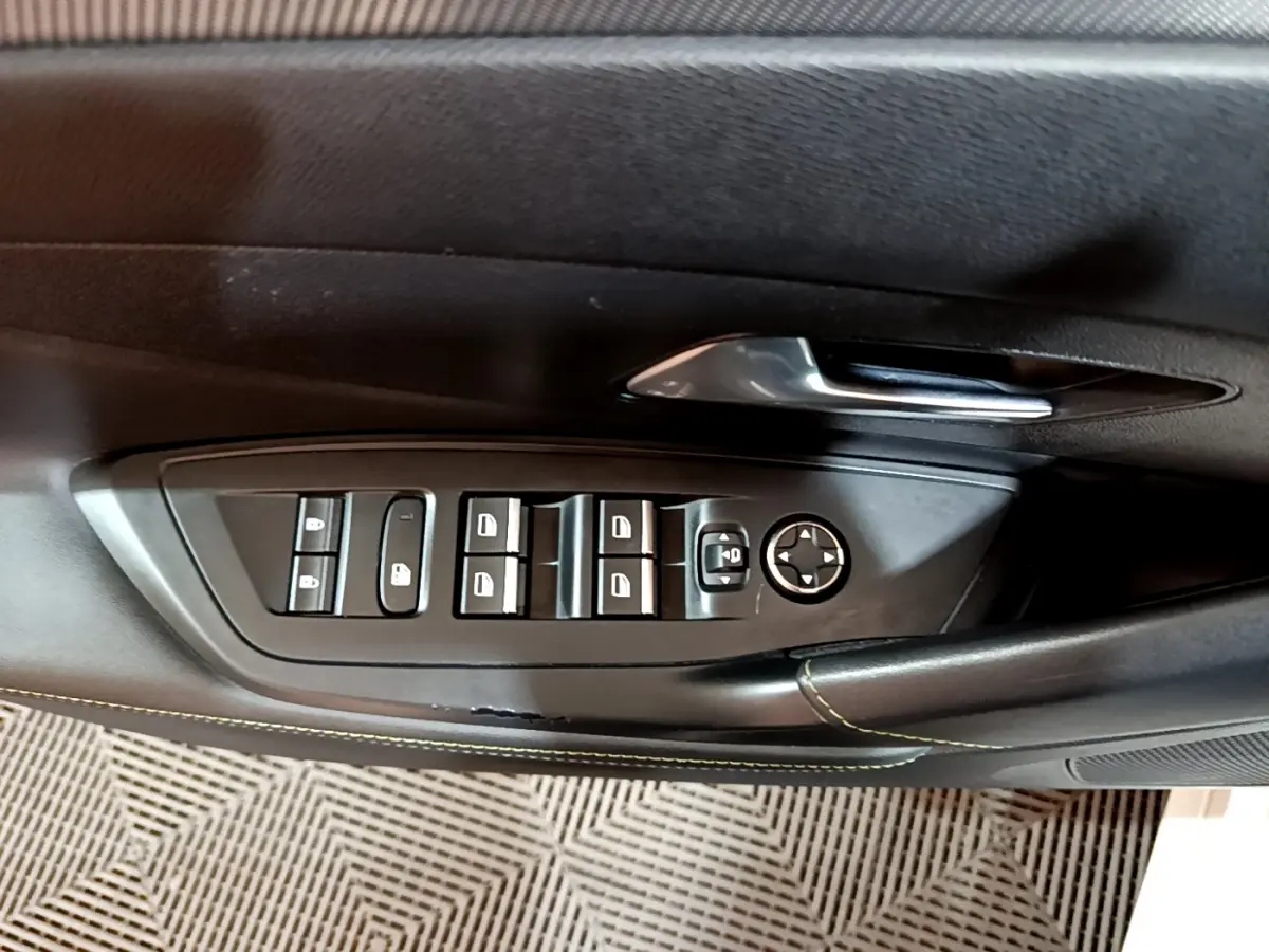 Panneau de commandes des vitres et rétroviseurs côté conducteur d'une Peugeot 308 PHEV 180 E-EAT8 GT 2022, intérieur noir.