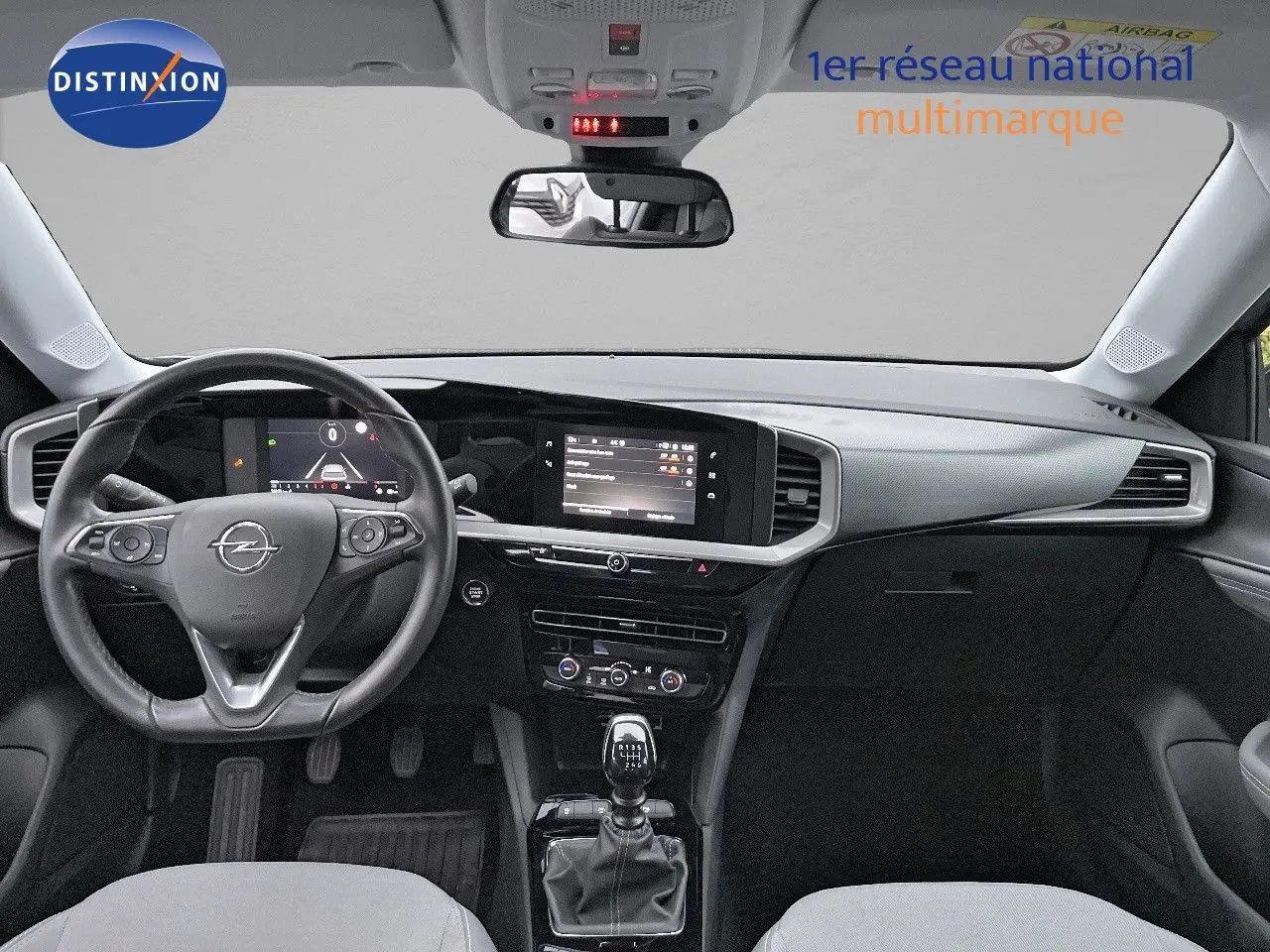 Intérieur de l'Opel Mokka 2021 vue de face, tableau de bord noir avec écran tactile et levier de vitesse manuel.
