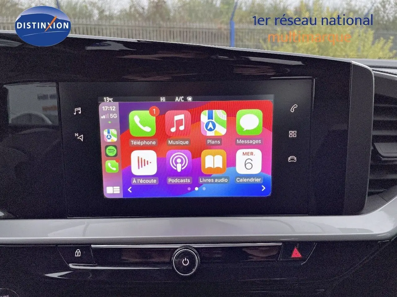 Écran tactile central allumé avec interface Apple CarPlay dans l'habitacle d'un Opel Mokka gris Artens 2021.