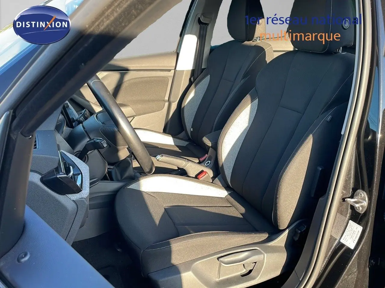 Intérieur du Skoda Kamiq noir magique métal 2024, vue côté gauche sur les sièges avant en tissu gris et noir.