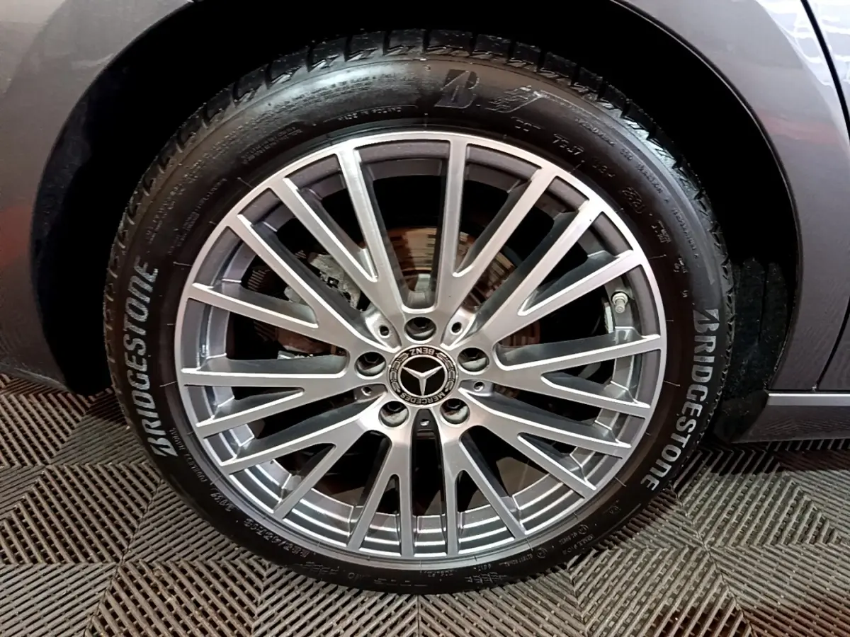 Gros plan sur la roue avant droite d'une Mercedes CLA 180 d Business Line gris clair avec jante alliage multi-branches.