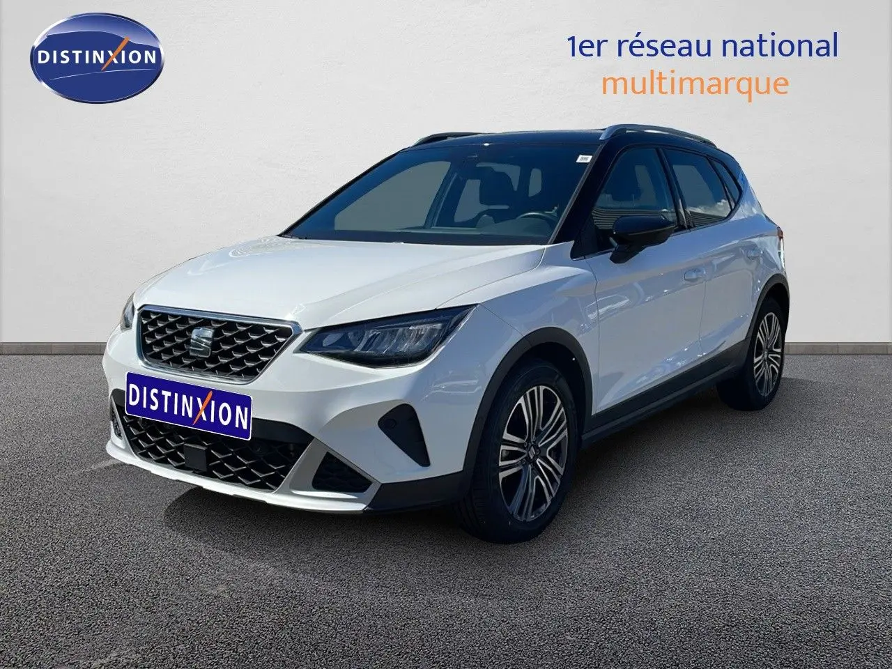 SEAT Arona blanc avec toit noir en vue 3/4 avant droit, mettant en valeur ses jantes alliage et calandre distinctive.