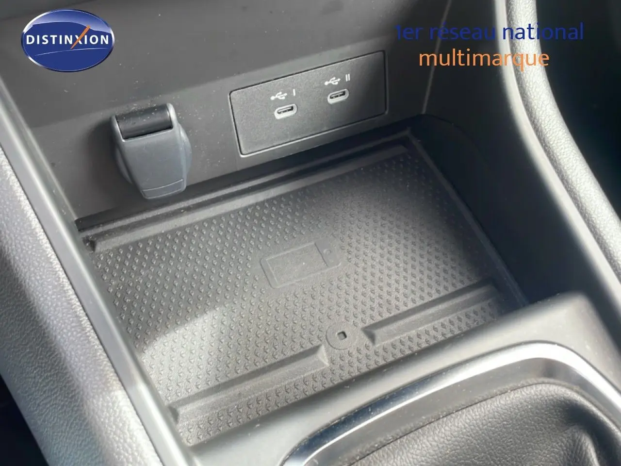 Gros plan sur la console centrale du Renault Captur 2025 avec ports USB-C et surface de recharge sans fil.