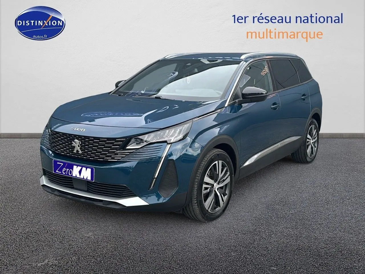 Peugeot 5008 bleu en 3/4 avant droit avec calandre chromée et jantes alliage 18 pouces visibles.