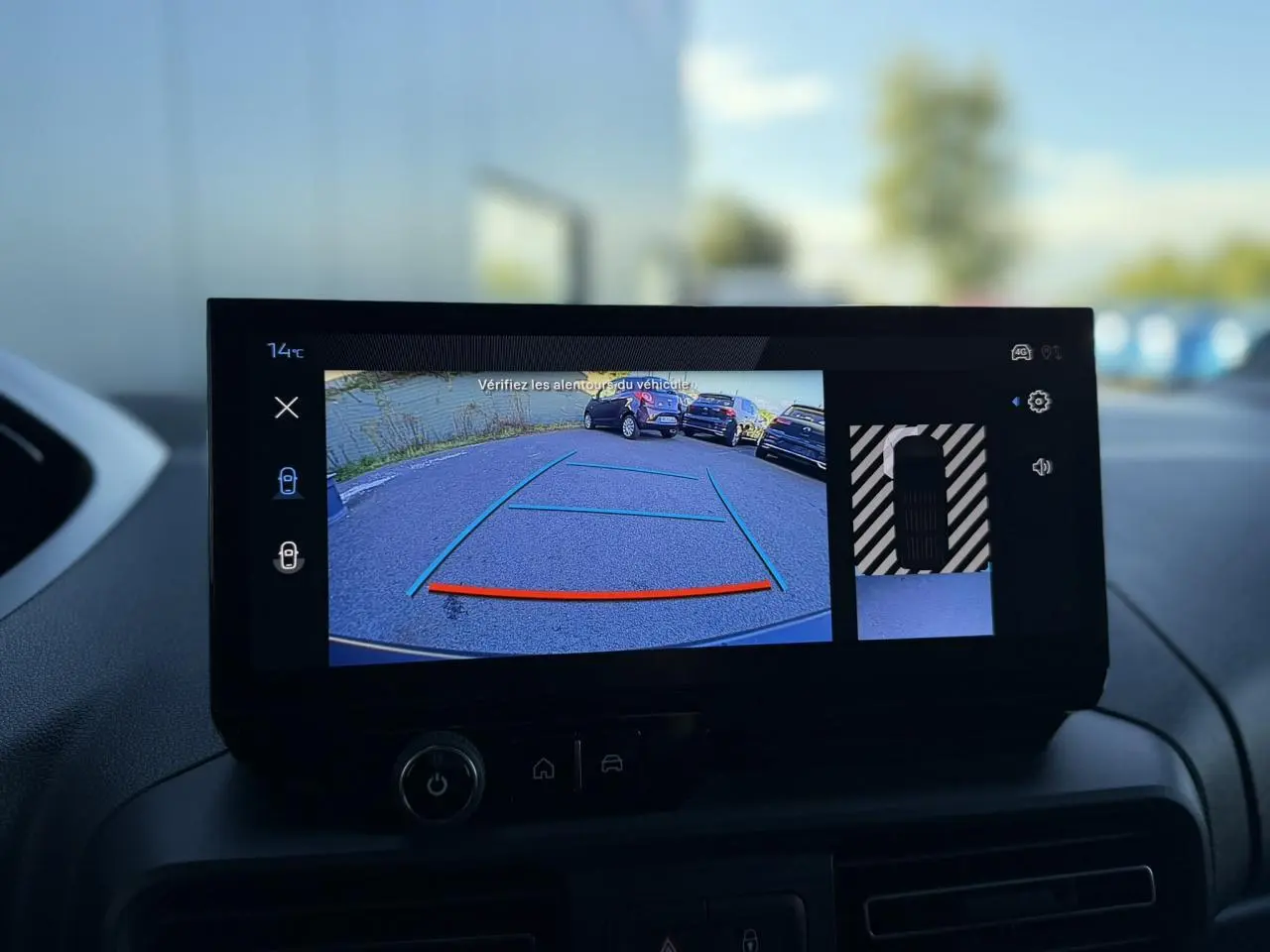 Écran tactile intérieur du Peugeot Partner 2026 montrant la caméra de recul avec lignes de guidage colorées.