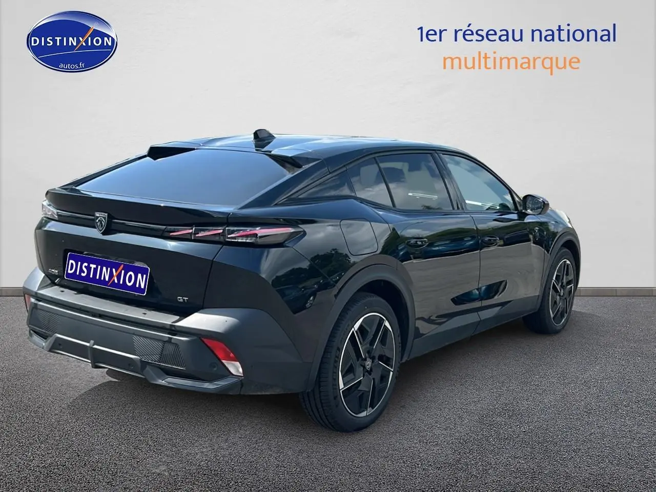 Vue 3/4 arrière droite d'une Peugeot 408 Hybrid 145 GT noire avec jantes alu et feux arrière LED distinctifs.
