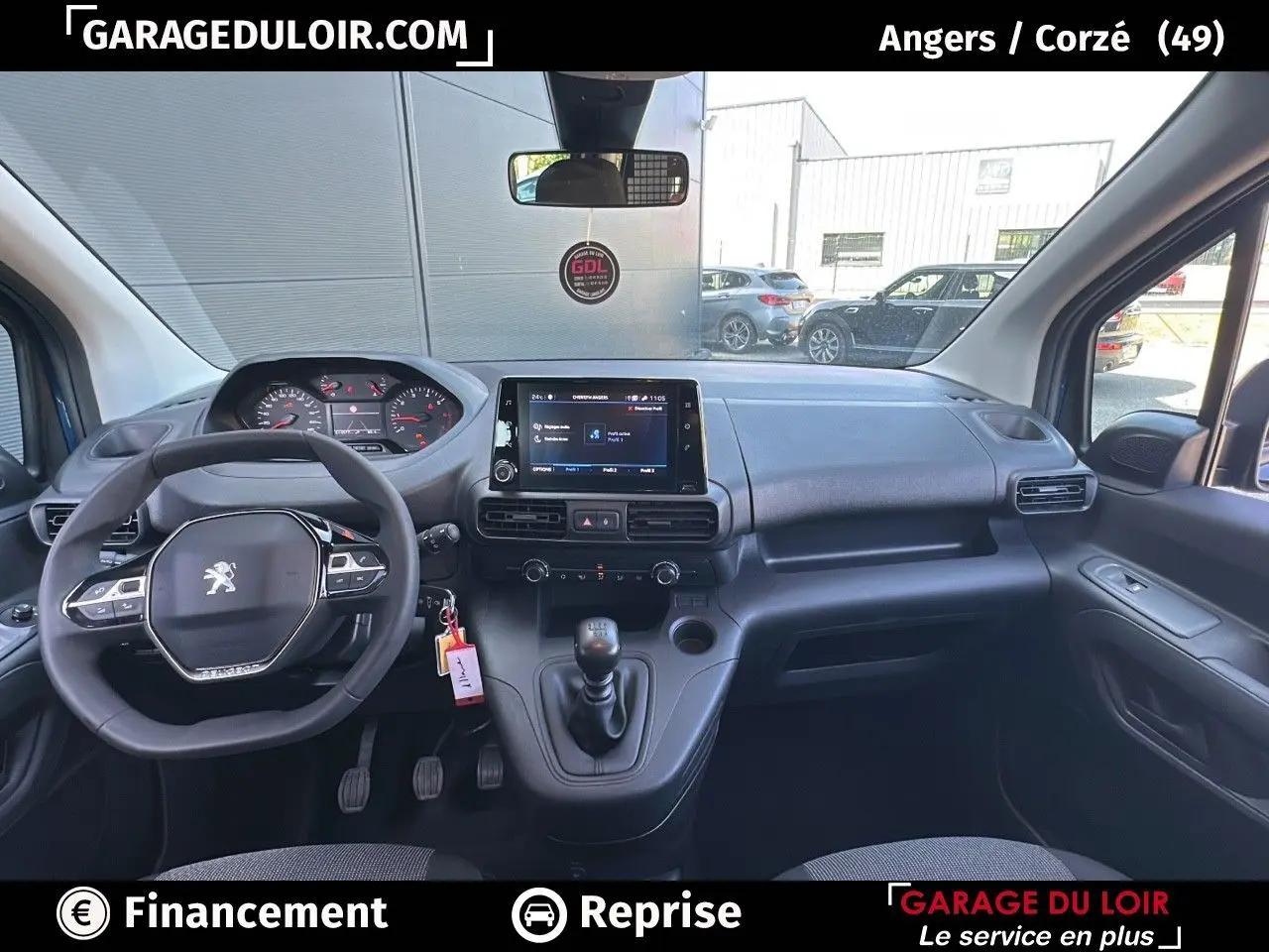 Intérieur Peugeot Rifter 2024 vu de face, tableau de bord noir avec écran tactile central et volant multifonction.