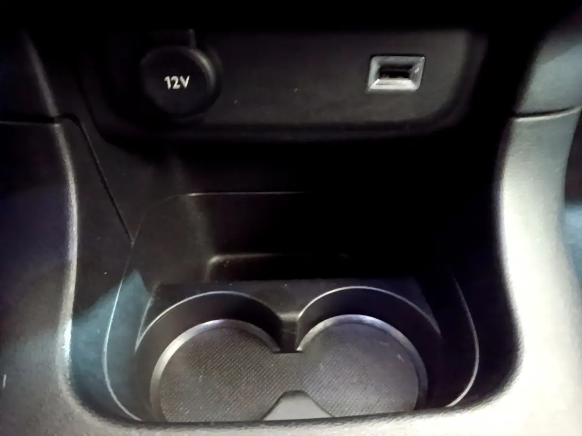 Gros plan sur la console centrale noire de la Citroën C3 2019 avec prise 12V et port USB visibles