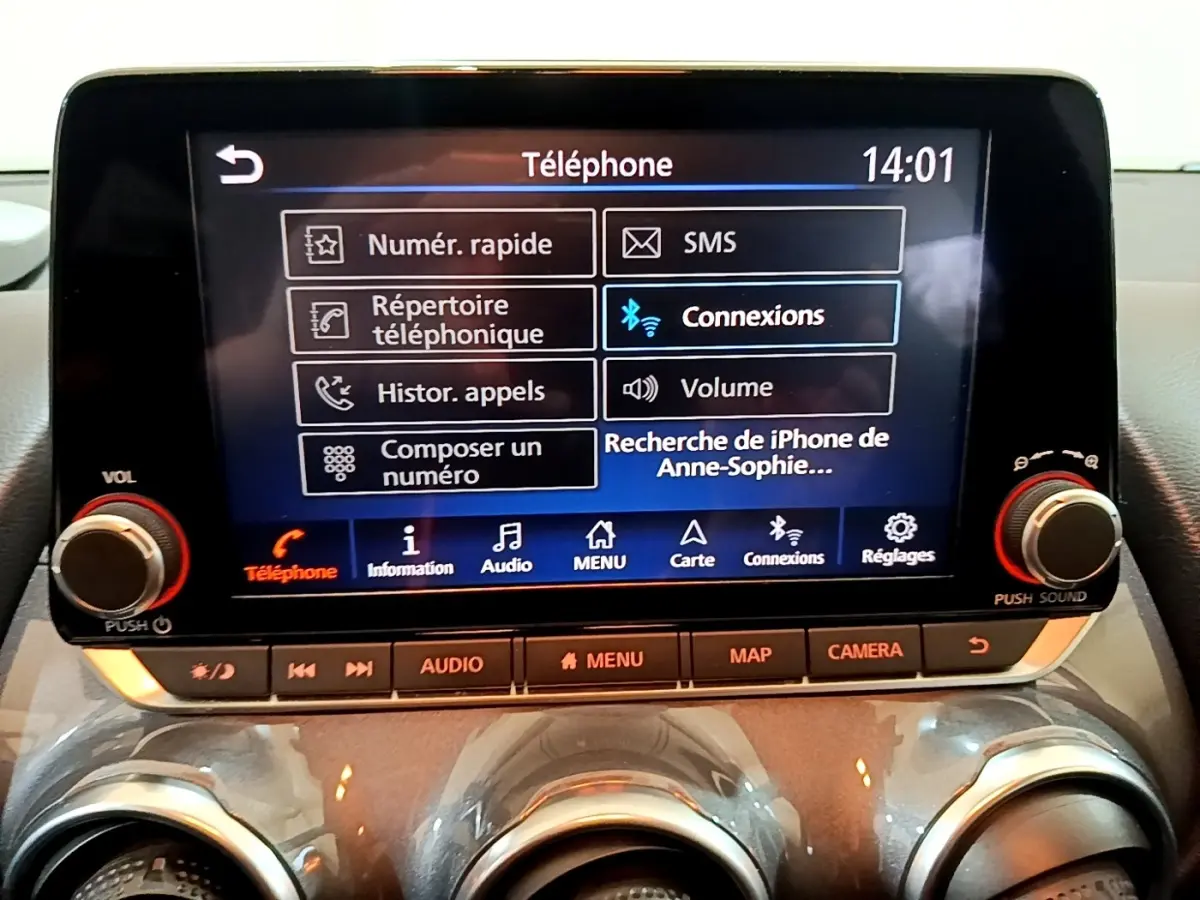 Écran tactile central du Nissan Juke Hybrid 2022 affichant le menu téléphone avec commandes autour, intérieur noir.