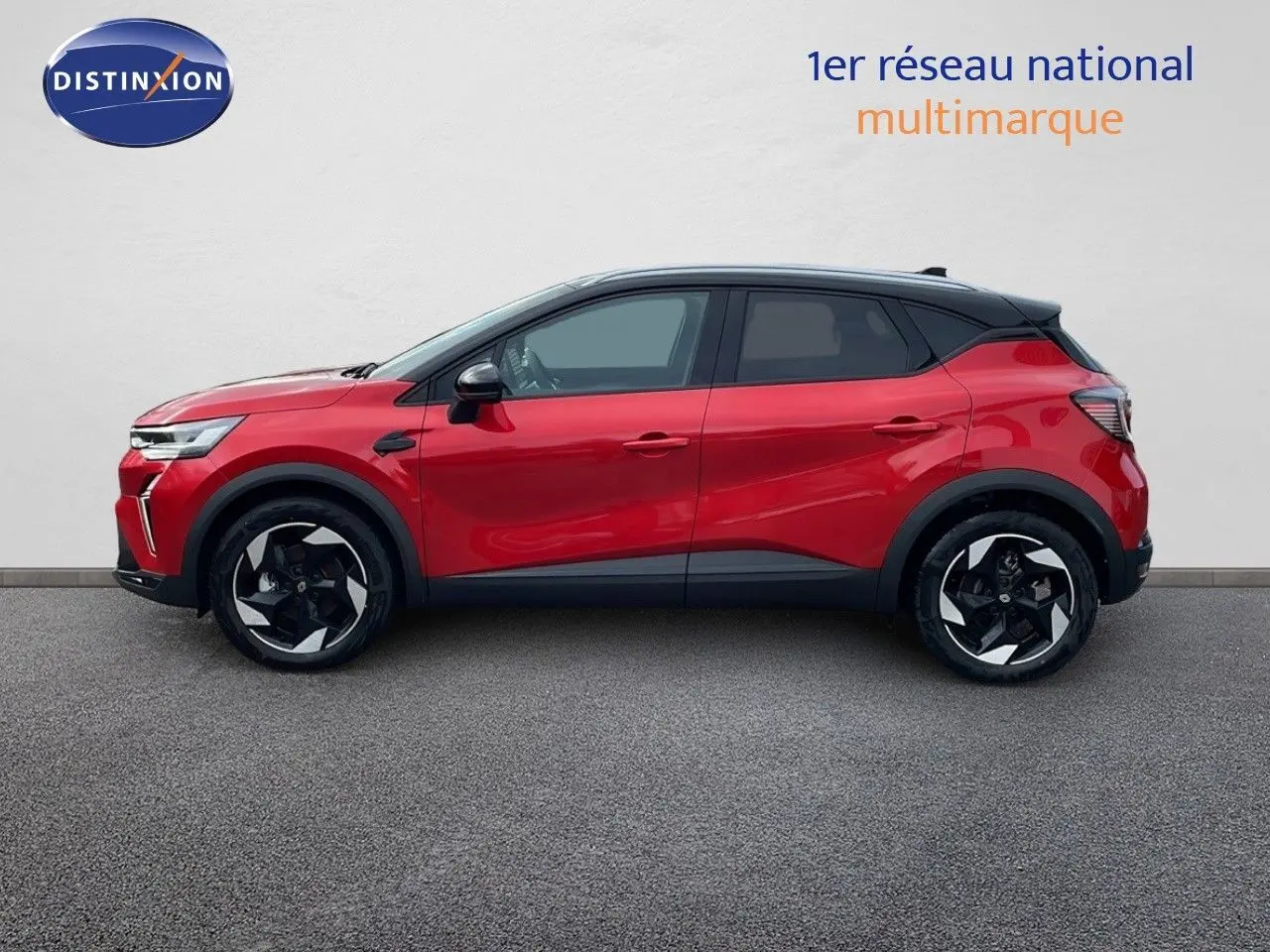 Profil côté gauche du Renault Captur E-Tech hybride 2025 rouge passion avec toit noir et jantes noires bicolores.
