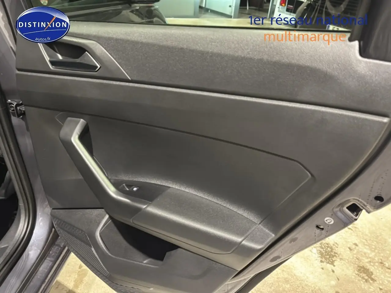 Vue rapprochée de la porte arrière gauche gris cendre de la Volkswagen Polo 2025 avec poignée intégrée et commande de vitre.