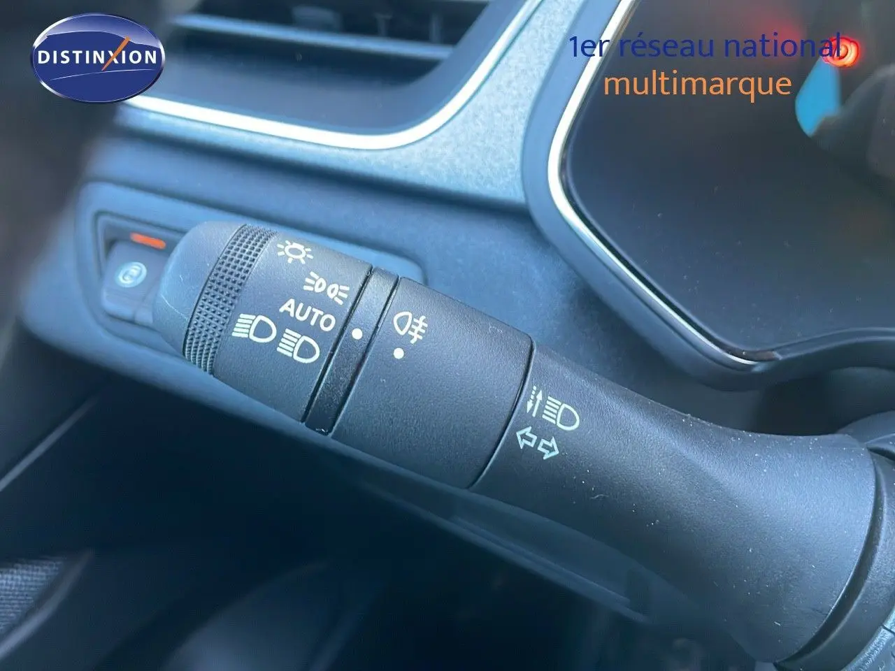 Gros plan sur la commande des phares et clignotants dans l'habitacle du Renault Captur blanc nacré 2025.