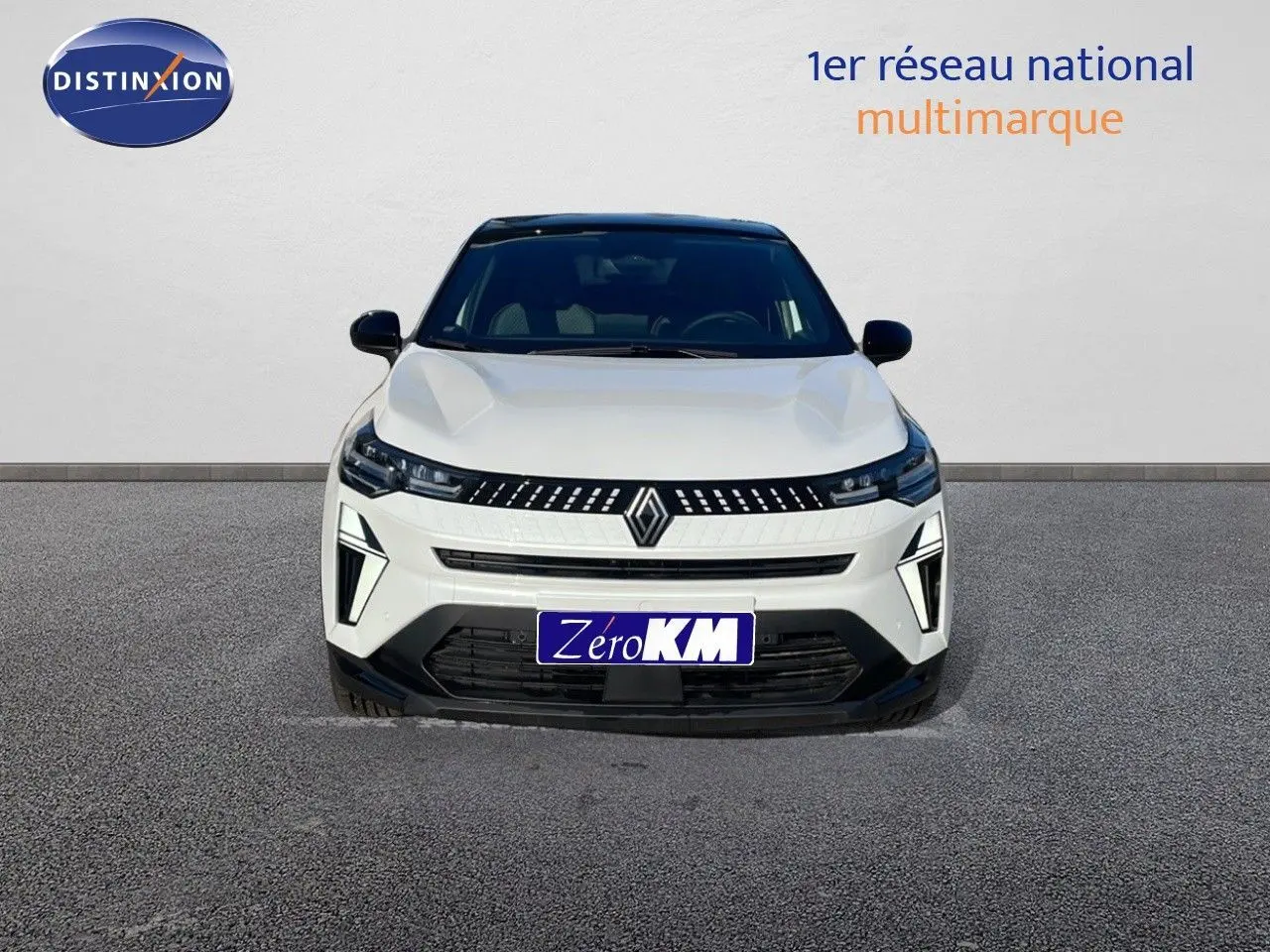 Vue frontale d'un Renault Captur blanc nacré avec toit noir, mettant en valeur sa calandre moderne et ses phares LED distinctifs.