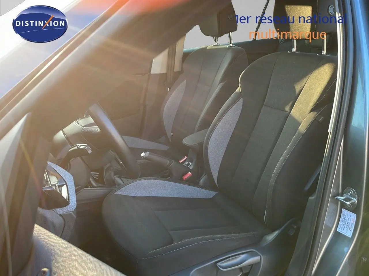 Intérieur du Skoda Kamiq 2024 en gris graphite métal, vue côté conducteur sur les sièges avant en tissu gris et noir.