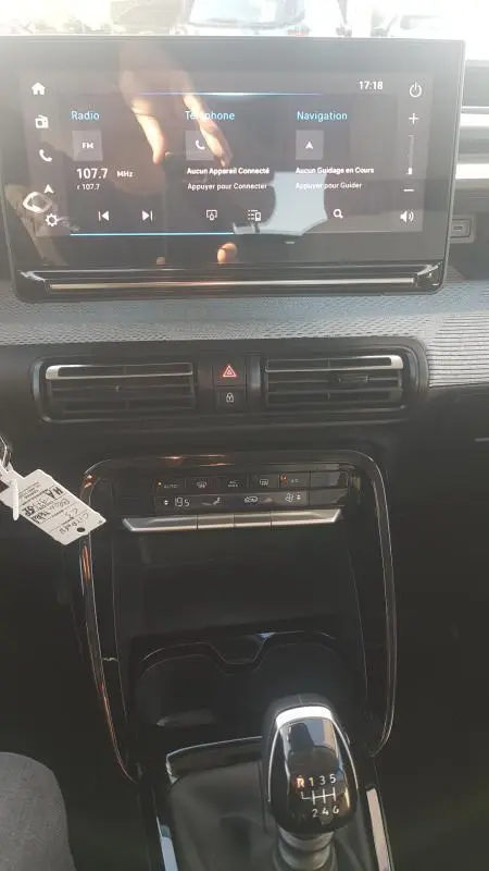 Vue intérieure centrée sur la console centrale et l'écran tactile du Citroën C3 2024 bleu foncé avec boîte manuelle 6 vitesses.