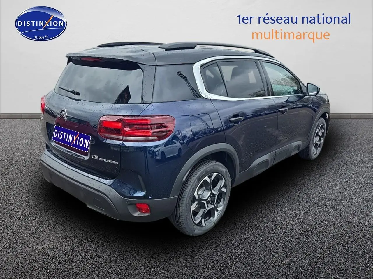 Vue 3/4 arrière droite d'un Citroën C5 Aircross bleu eclipse avec jantes alliage et vitres teintées.