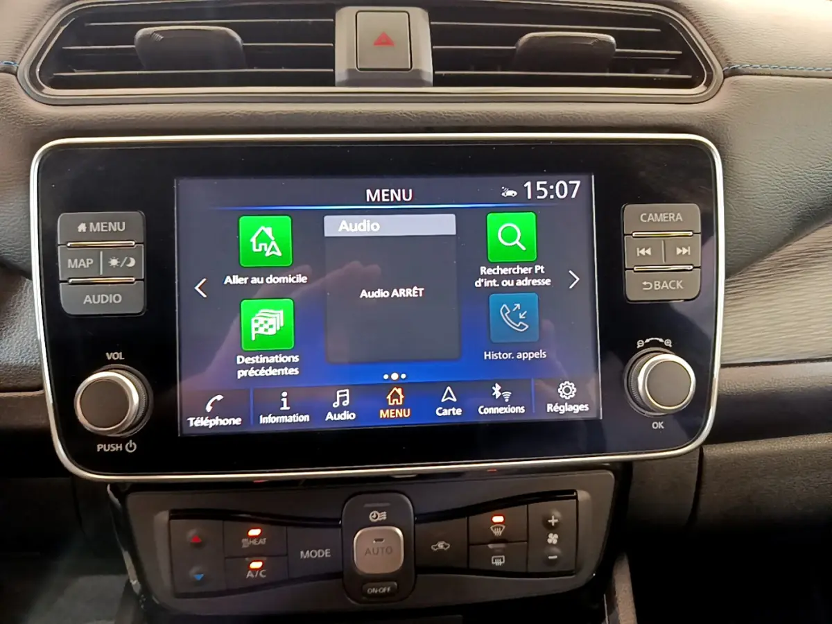 Vue rapprochée du tableau de bord noir de la Nissan LEAF 62 kWh 217ch Business+ avec écran tactile multimédia allumé.