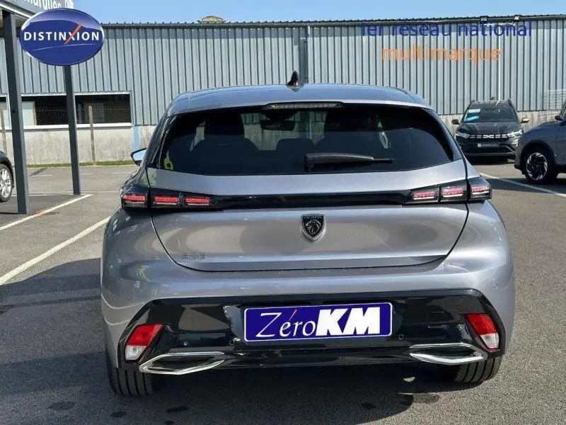 Vue arrière d'une Peugeot 308 gris Artense 2025 avec feux arrière LED et double sortie d'échappement chromée.
