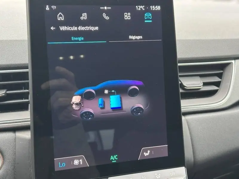 Écran central du tableau de bord du Renault Captur 2025 affichant l'énergie du système hybride, intérieur noir.