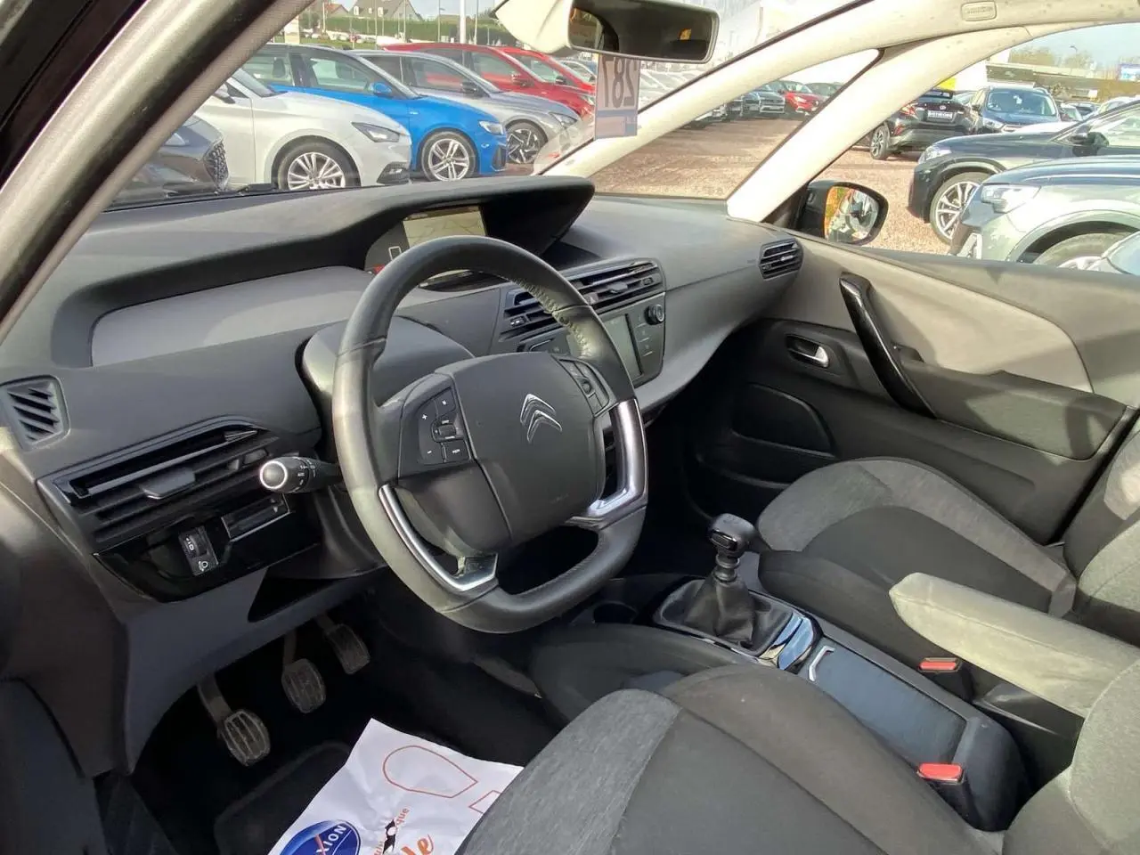 Vue intérieure côté conducteur du Citroën C4 Spacetourer noir 2019 avec volant multifonction et boîte manuelle.