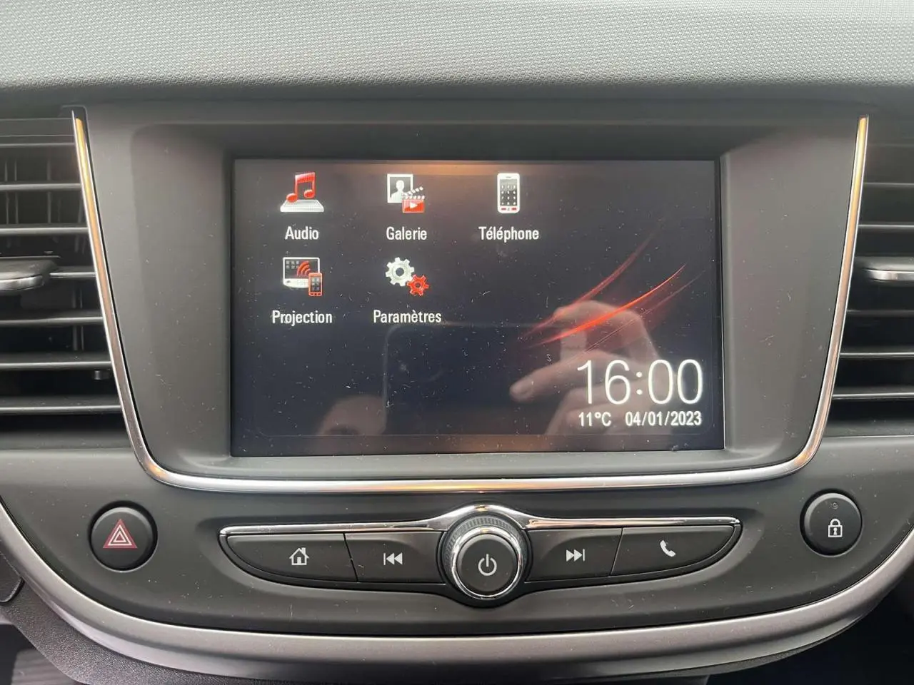 Écran tactile central du système multimédia de l'Opel Crossland rouge, affichant les options audio et téléphone.