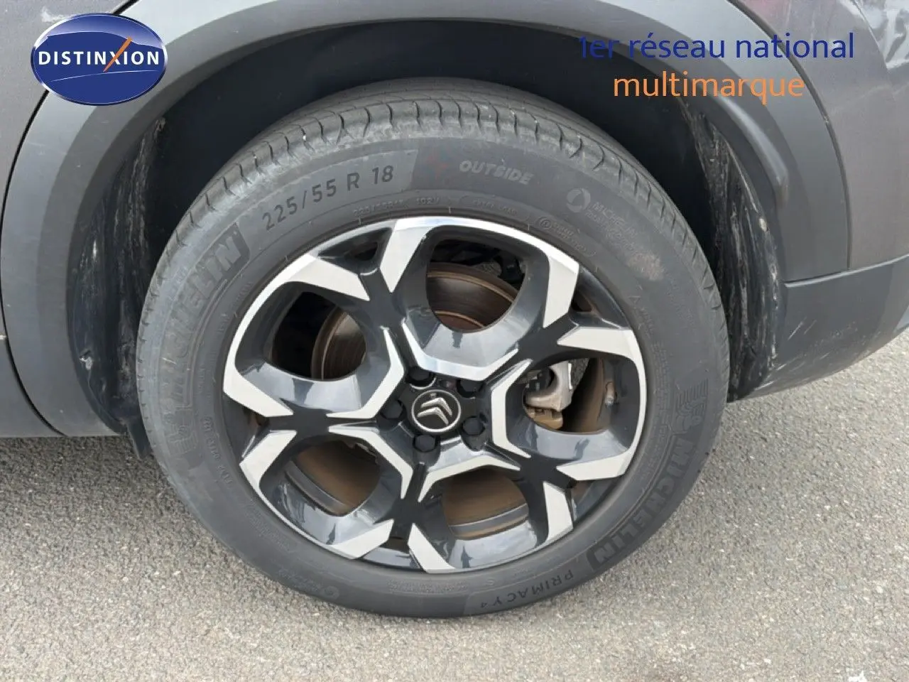 Gros plan sur la roue arrière droite du Citroën C5 Aircross gris platinium avec jante alliage bicolore distinctive.