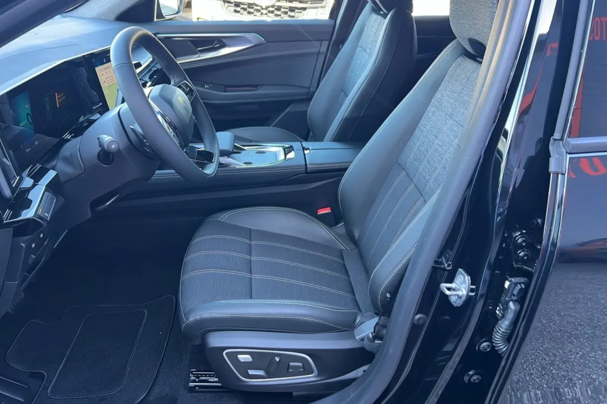 Intérieur côté conducteur du Renault Austral E-Tech 200 Techno 2025 en noir étoilé, sièges et tableau de bord visibles.