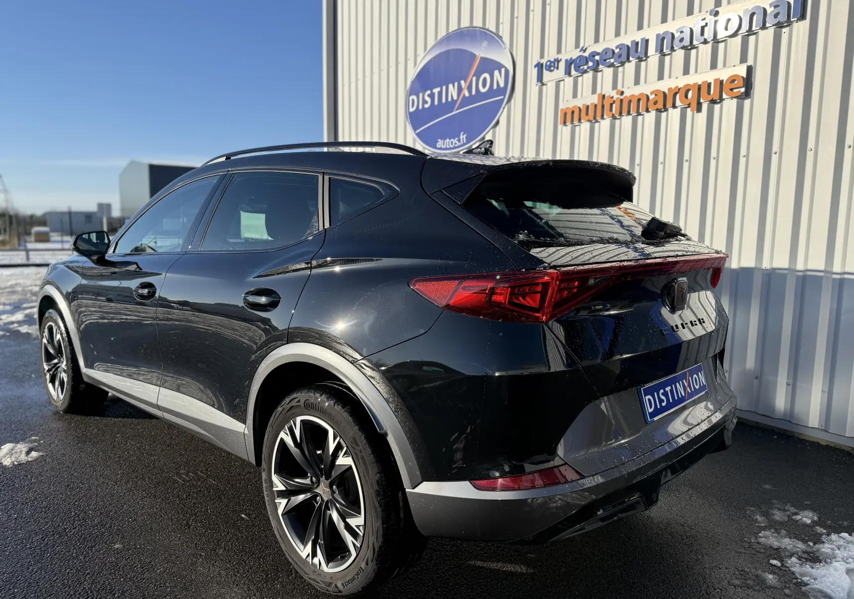 Vue 3/4 arrière droite d'un CUPRA Formentor noir minuit 2023, avec feux LED et jantes alliage bicolores.