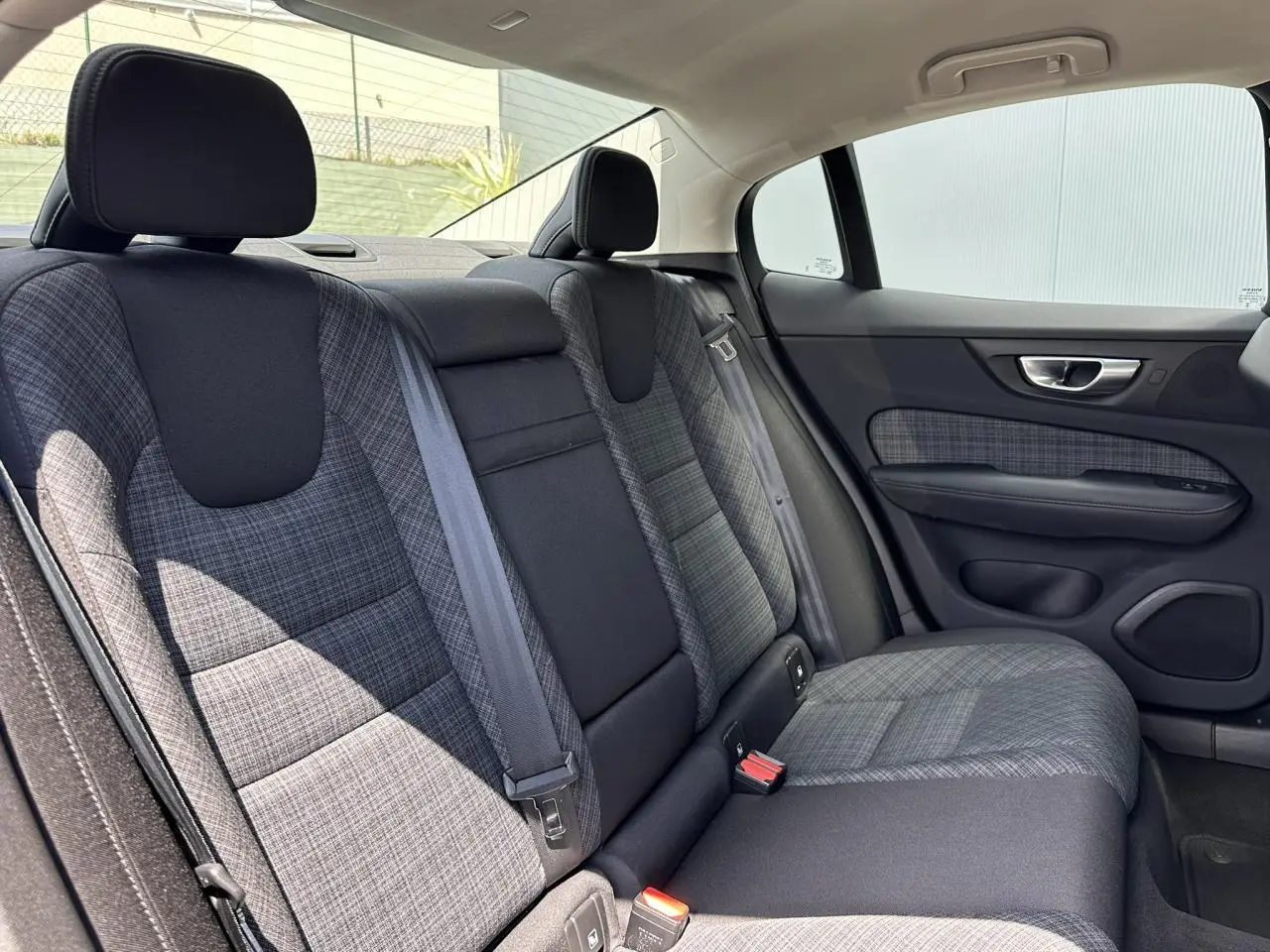 Vue intérieure côté droit des sièges arrière en tissu gris à motifs de la Volvo S60 B4 197 DCT7 MHEV Core+ 2024.