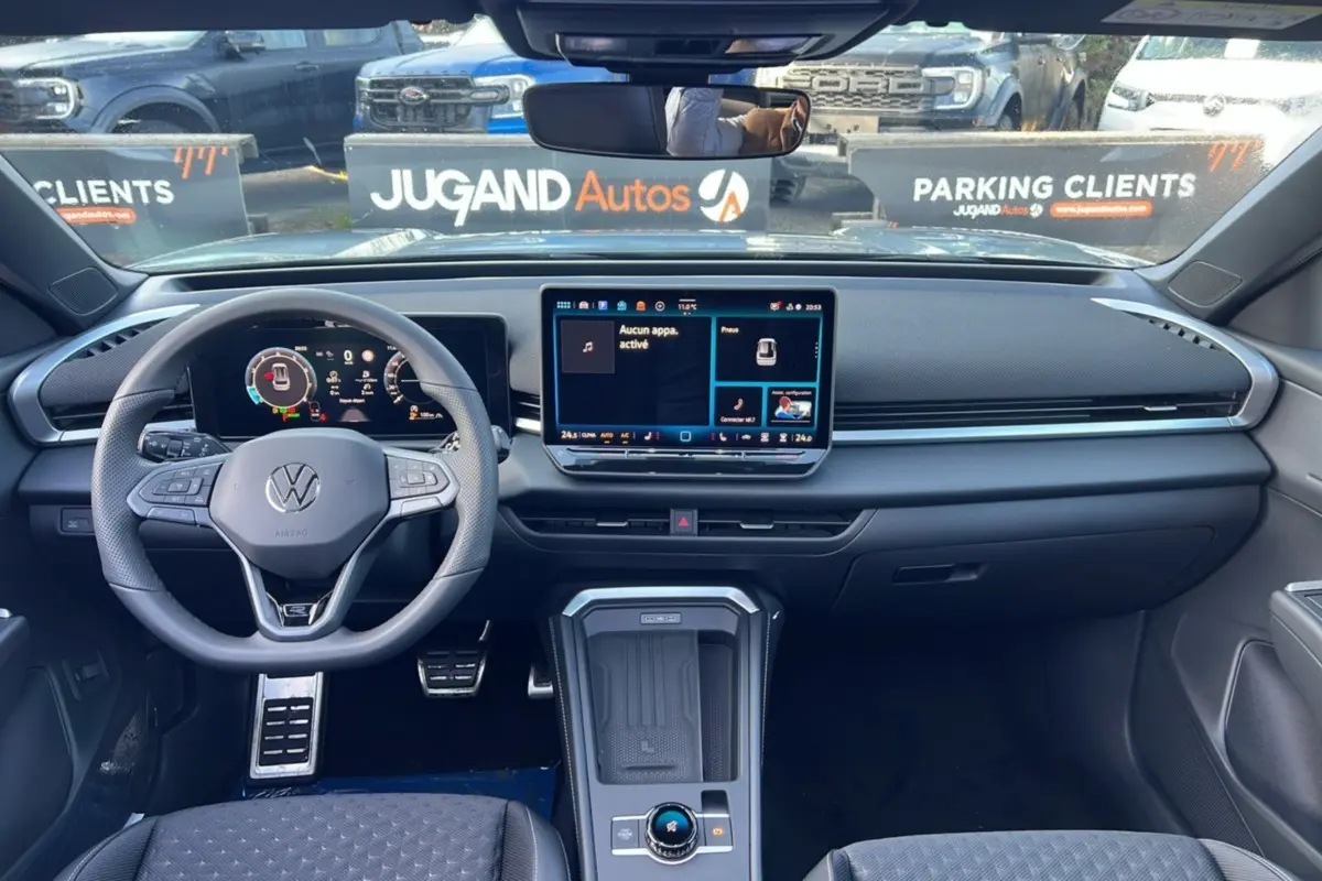 Vue intérieure frontale du Volkswagen T-Roc 2026, tableau de bord moderne avec écran tactile et volant multifonctions cuir.