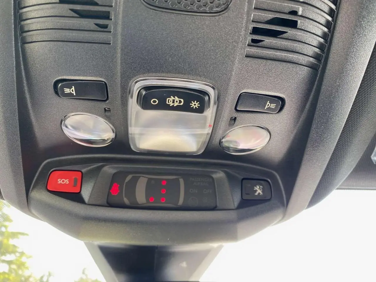 Vue en gros plan du plafonnier avec boutons SOS et éclairage du Peugeot 3008 gris platinium 2023.