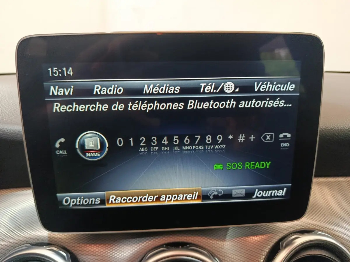 Écran central multimédia affichant la recherche Bluetooth dans l'habitacle du Mercedes GLA gris clair, vue de face.