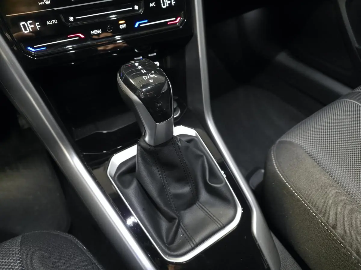 Le levier de vitesse automatique noir et argenté du Volkswagen T-Roc 2024, vue rapprochée de la console centrale.