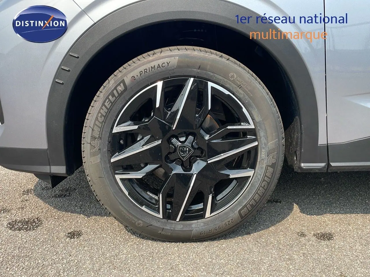 Gros plan sur la roue avant gauche du Peugeot 3008 gris Artense avec jante alliage noire et argentée design moderne.